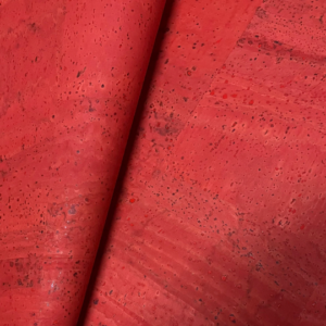 This is a coral red superior cork fabric