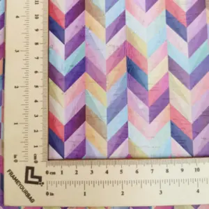 This is a chevron printed pattern on white rustic cork fabric